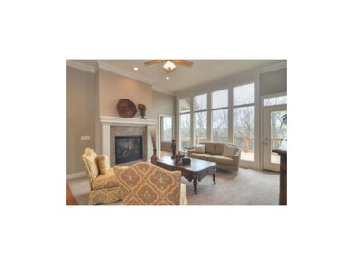 Living Room w/see thru fireplace.  Wall of windows