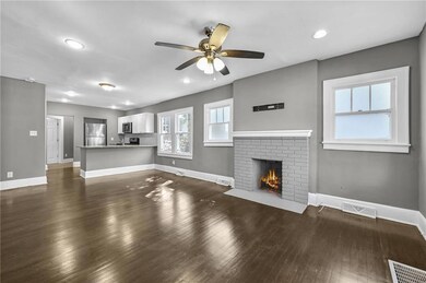 Unfurnished living room with dark wood-style floor