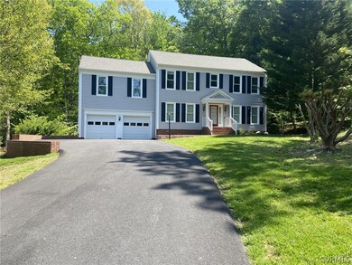 Colonial-style house featuring a garage and a fron