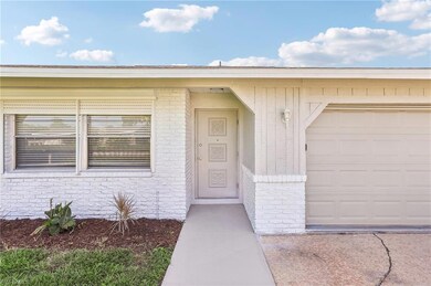 Doorway to property featuring a garage
