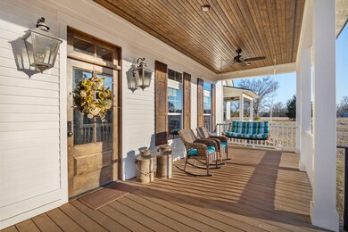 Wooden terrace featuring a porch and ceiling fan