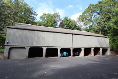 Garage for one vehicle with individual enclosed,lockable storage room.
