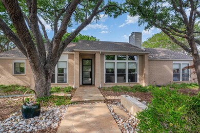 View of front of property with a shingled roof, a 