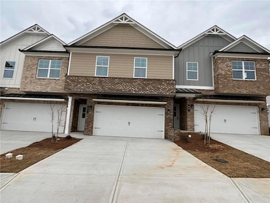View of front facade with a garage, brick siding, 