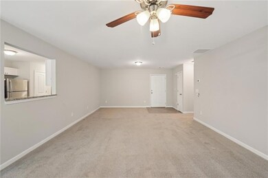 Unfurnished room with light colored carpet, basebo