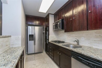Kitchen features granite counters, stainless steel