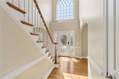 Entryway featuring wood finished floors, stairway,