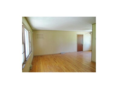 Large Living Area With Wood Flooring.