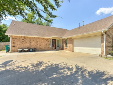 Single story home with a shingled roof, an attached garage, and brick siding