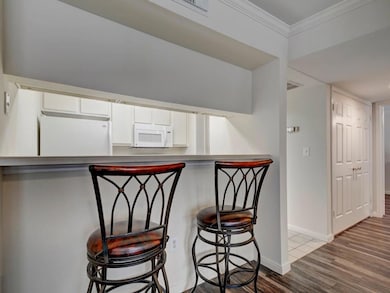 Kitchen featuring white appliances, wood finished