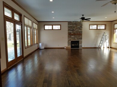 Newly added Recreation Room with fireplace, hardwood floors and patio doors.