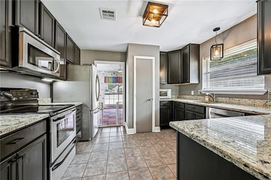 Updated Kitchen – Granite countertops, stainless steel appliances, and abundant cabinet space combine style and function.