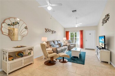 Tiled living room featuring ceiling fan and high v