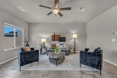 Living area featuring ceiling fan and baseboards