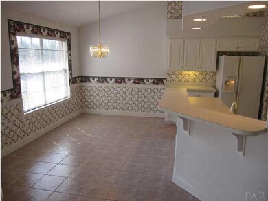 View of the breakfast area with tile flooring. Access to the screened lanai & pool to your left.