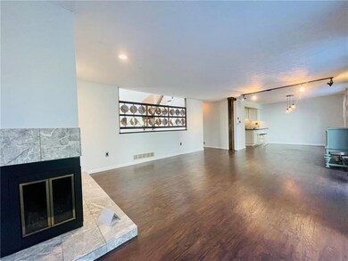 Enjoy the Warmth from this Corner Fireplace at End