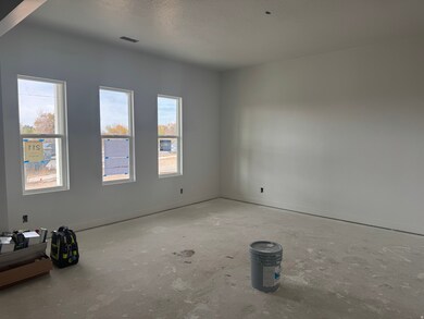 Empty room featuring a textured ceiling and concrete floors