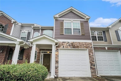 Multi unit property with stone siding, driveway, and a garage