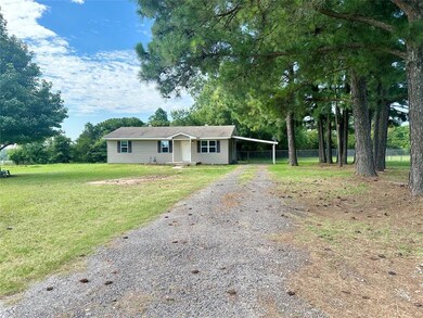 Ranch-style house with a carport and a front yard