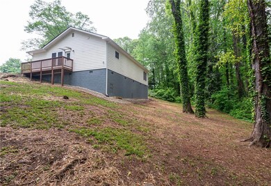 Rear view of property with a deck and crawl space
