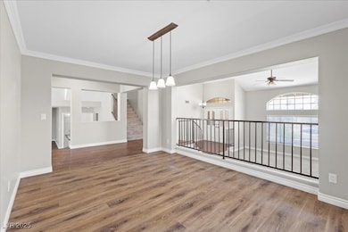 Unfurnished room with wood finished floors, crown
