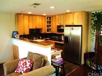 Granite kitchen with recessed lighting, wood grade