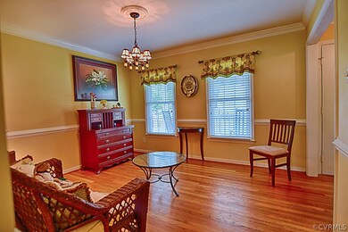 Formal dining room with gleaming hardwood floors,