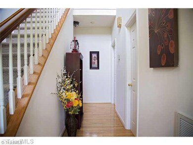 Entry. Beautiful entry with hardwood flooring.  The first door on the right is the half bath.  Second door on the right leads to the master suite.  To the left of the steps, not shown, is the entry to the great room.