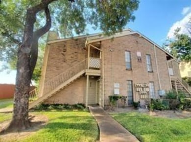 This photo shows a two-story brick apartment build
