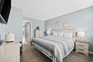 Bedroom with baseboards and a textured ceiling