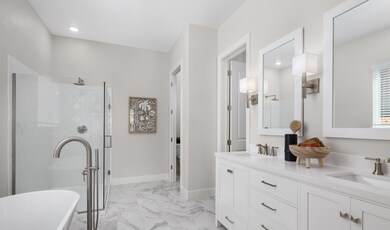 Primary suite with freestanding vanity and freestanding tub