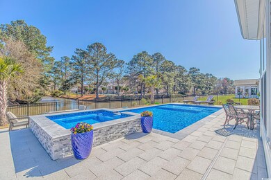 View of swimming pool featuring an in ground hot t