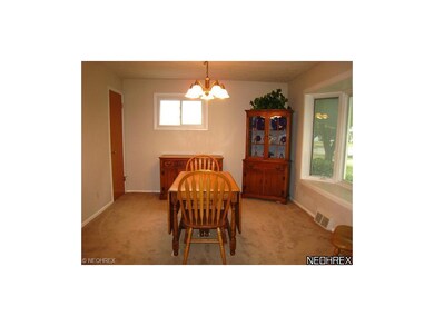 Dining room with newer Pella bay window and carpet