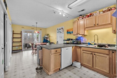 Kitchen with sink, hanging light fixtures, a textu