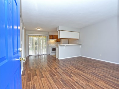 Unfurnished living room with dark wood-style floo