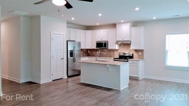 Perfectly designed kitchen hosting pantry closet, granite counter tops, tile backsplash, recessed lighting, deep sink in island with high arc faucet/sprayer and painted cabinetry.  Stainless appliance package includes smooth top electric stove, micro