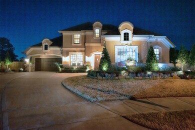 A view of the home in the evening showing the great landscaping lighting installed. 