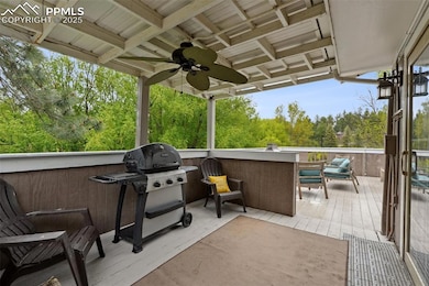 View of patio featuring a ceiling fan, grilling area, and a deck