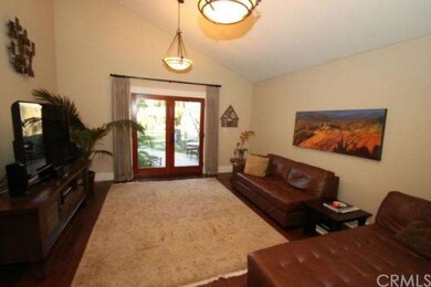 Living Room tall ceilings, skylight, and French do