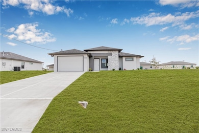 Prairie-style home with driveway, cooling unit, a