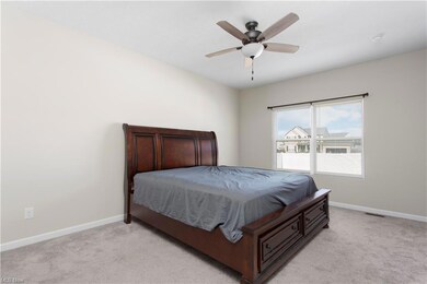Bedroom with light carpet and ceiling fan