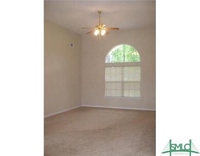 The living room boasts high ceilings and large windows that allow for tons of natural light!