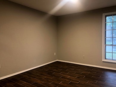 Unfurnished room with dark wood-type flooring and 