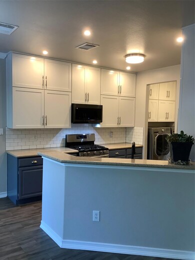 Kitchen featuring decorative backsplash, washer /