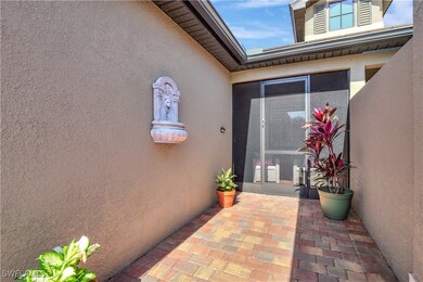 Entrance to property featuring a patio and stucco