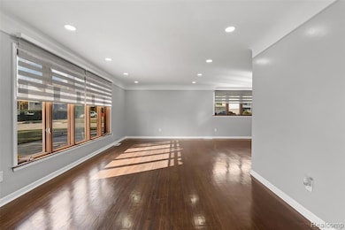 Spare room with dark wood-style flooring and recessed lighting