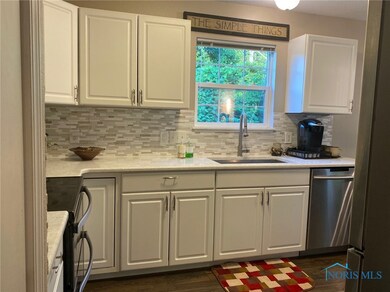 Kitchen with Quartz Counters and White Cabinetry