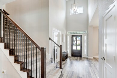 GRAND 2-STORY ENTRY WAY GREETS YOU AS YOU ENTER THE HOME.