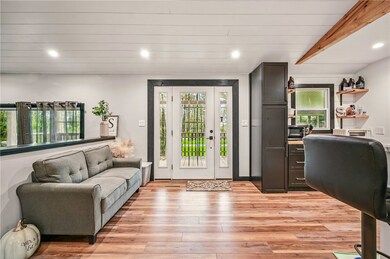 Open floor plan with kitchen, dining, sitting area