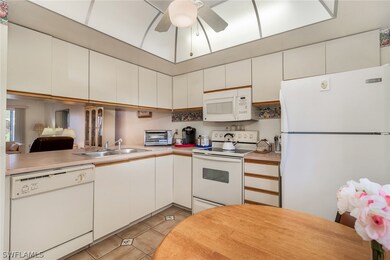 Large kitchen pass-through window opens to breakfast bar, dining area